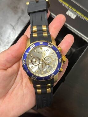 Invicta Gold Tone Watch with Blue Bezel and Black Strap